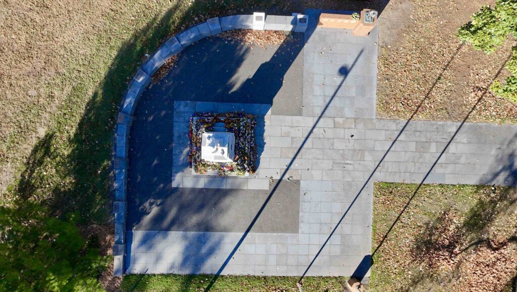 A top-down aerial shot of the Box Hill cenotaph, highlighting the geometric layout of the dark and light stone pavers supplied by Eigen Stones.

