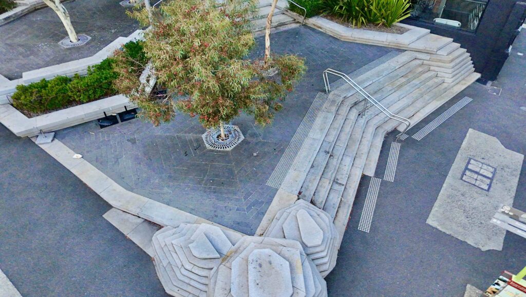 An aerial view of the sculptural stone planters and integrated seating at Hampshire St, creating organic shapes in the paved plaza. Stone supplied by Eigen Stones.