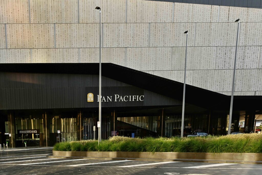 The modern facade of the Pan Pacific hotel, part of the Melbourne Convention Centre precinct, featuring a durable stone-paved drop-off area supplied by Eigen Stones.
