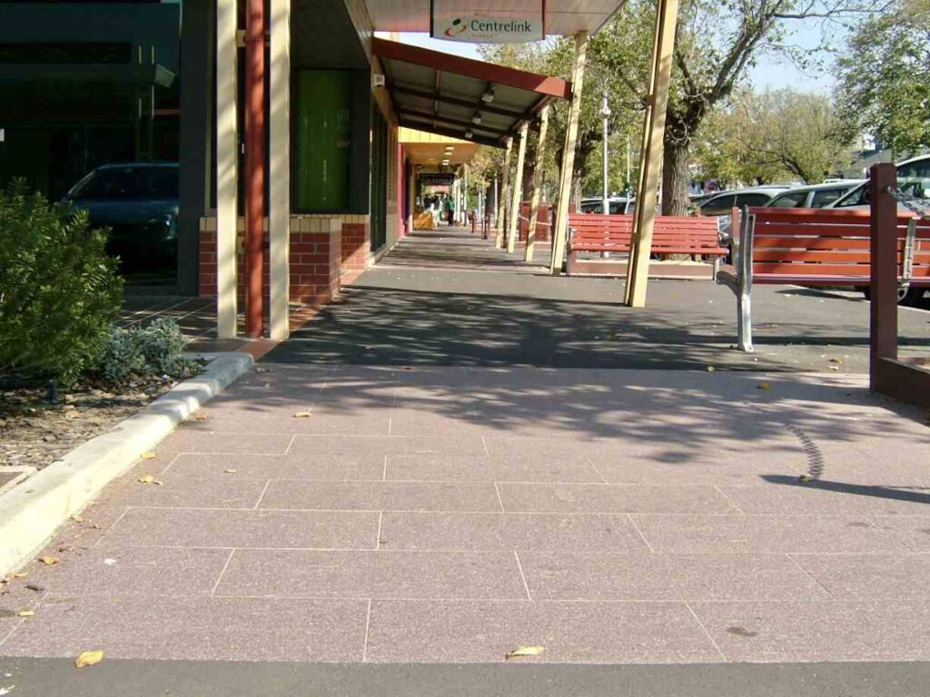 A long view of the covered walkway at Sunbury Mall, paved with durable, large-format stone pavers supplied by Eigen Stones.