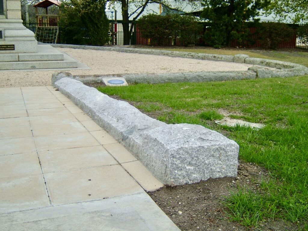 A detailed shot of the natural, rock-faced stone kerbing defining the garden edge at the Sunbury memorial, supplied by Eigen Stones.