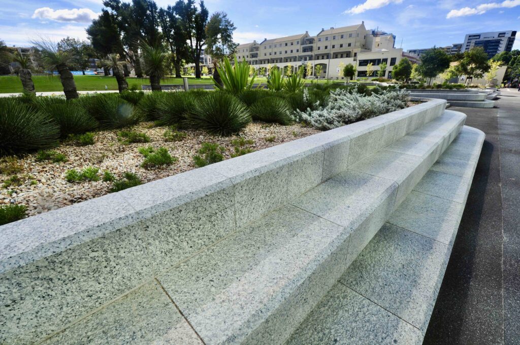 The grand, terraced stone seating at Uni Square, designed as both a retaining wall and a gathering place, featuring materials from Eigen Stones.