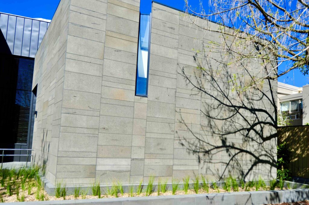 A detailed shot of the textured stone cladding on a building facade at St Kevin's, showcasing the quality of the materials supplied by Eigen Stones.