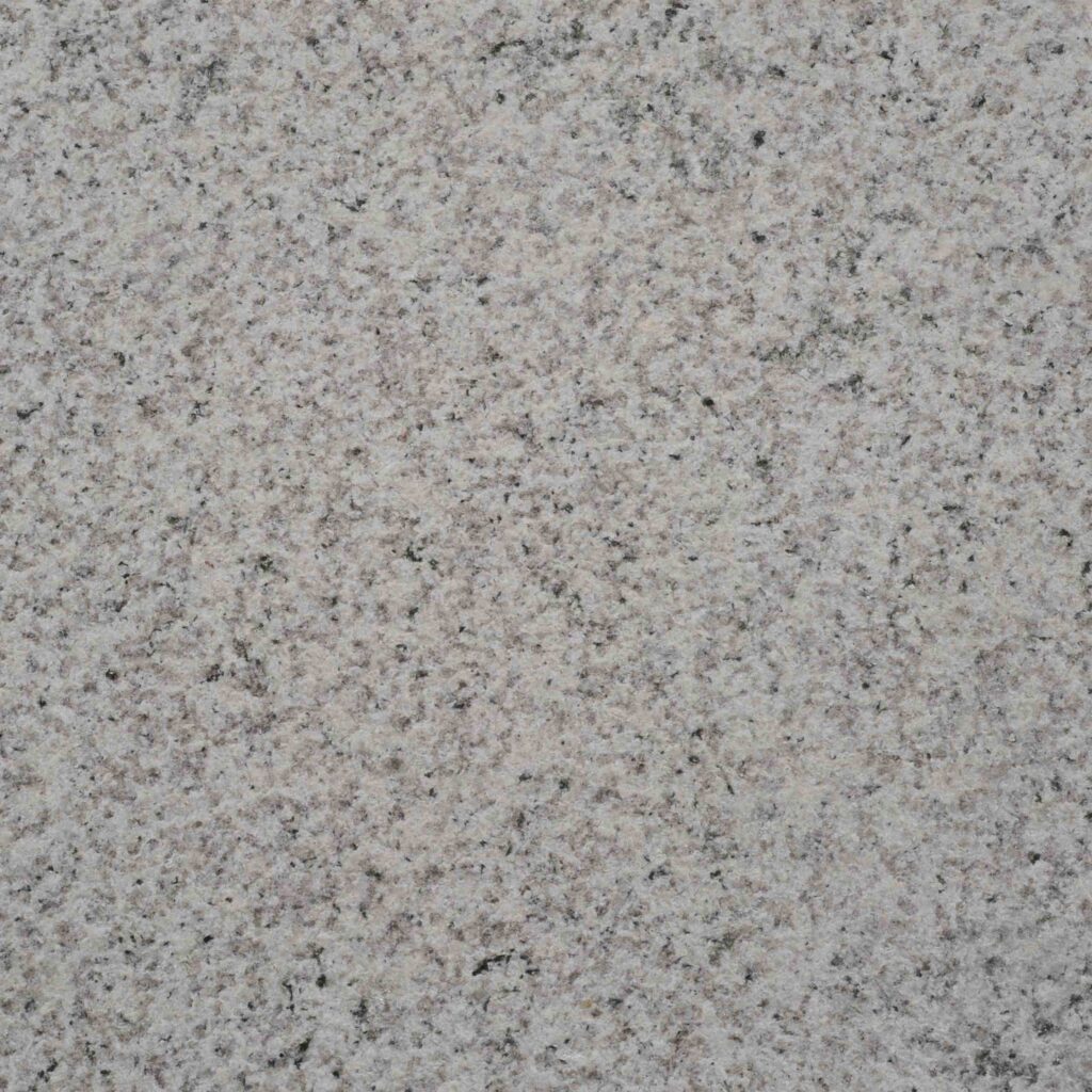 Feline_BH.jpg: A detailed macro photograph of the Feline Bush Hammered paver, showcasing its classic 'salt and pepper' grain and finely textured, sparkling surface.